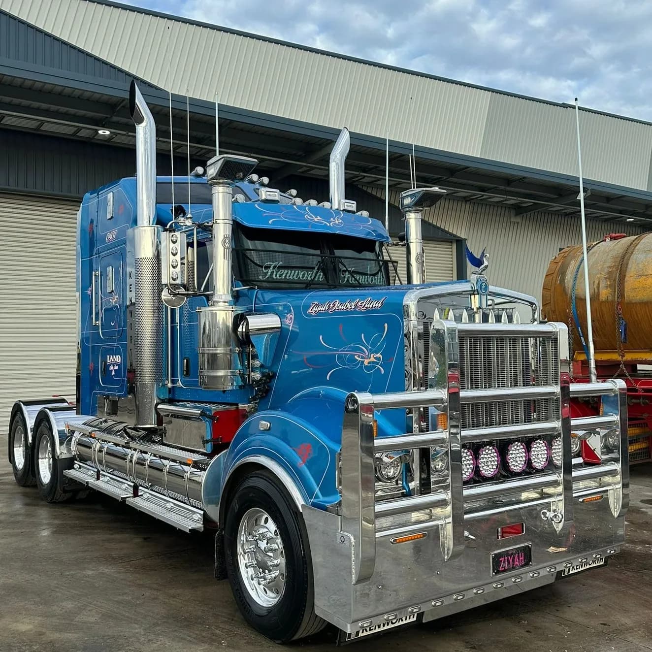 Detailed blue Kenworth with chrome stacks and bullbar