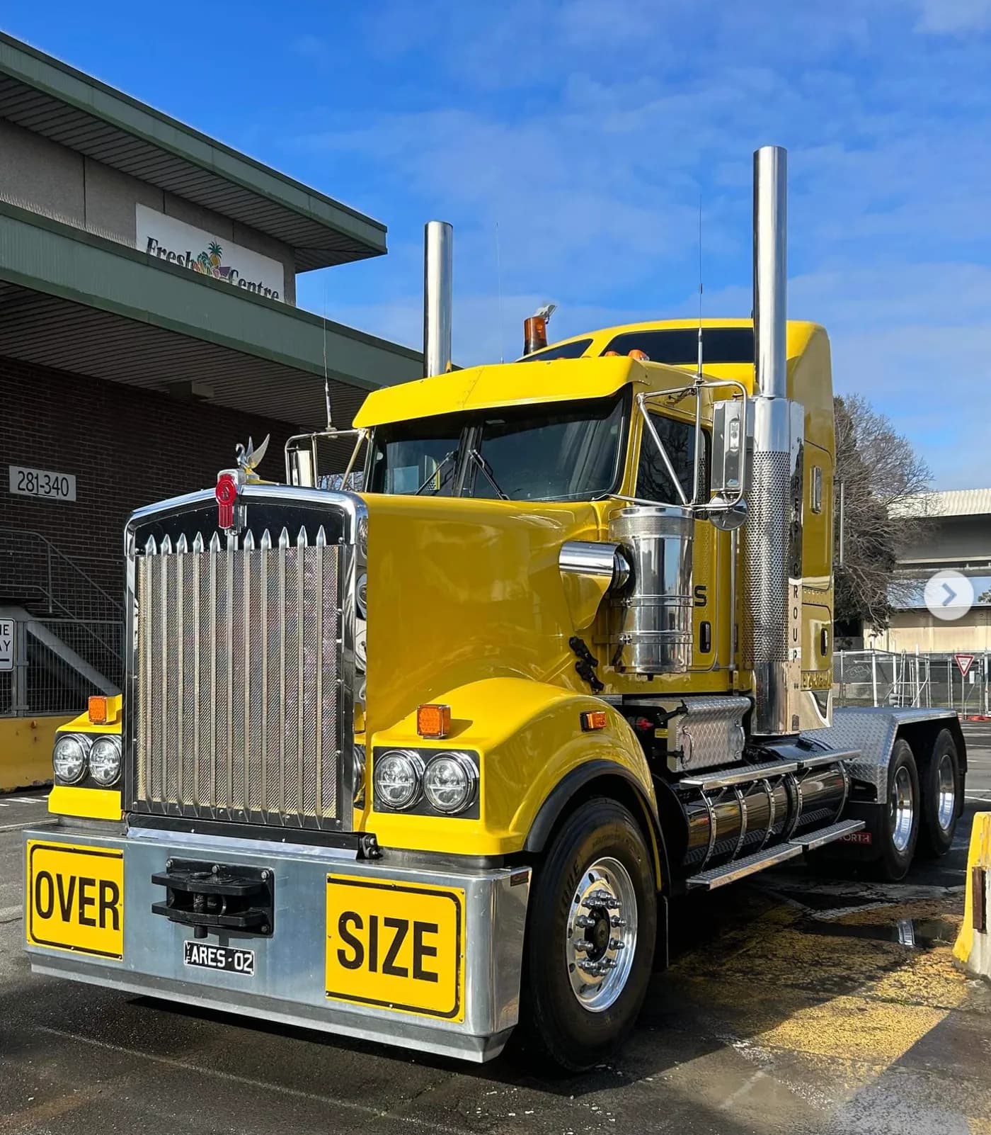 Yellow Kenworth oversize prime mover
